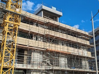 Under construction residential building with Concreate Block structure and Fixed Tower Crane.
Exterior viewHighrise Multistory building modern design,
Yellow Fixed Tower Crane and erected Scaffolding.