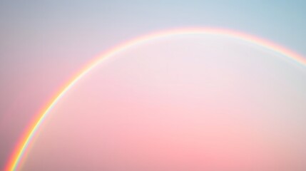 Fototapeta premium Pastel colored rainbow arching across a soft sky.