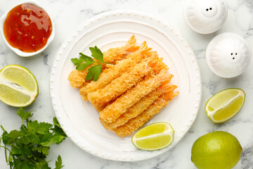 Tasty tempura shrimps served on white marble table, flat lay