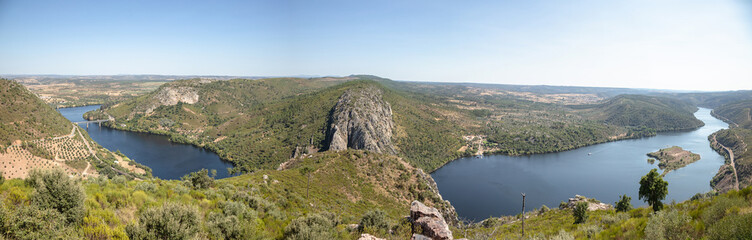 Breathtaking aerial view of the winding Tejo River flowing through lush green hills in August. Serene and panoramic view of extensive landscape in Vila Velha de Rodao, Portugal.