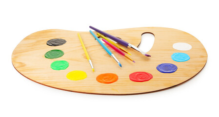 Wooden palette with paints and brushes isolated on white
