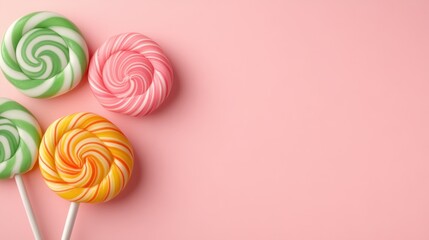 A collection of vibrant swirl lollipops set against a soft pink background, appealing to the playful and nostalgic emotions connected with sweets and childhood memories.