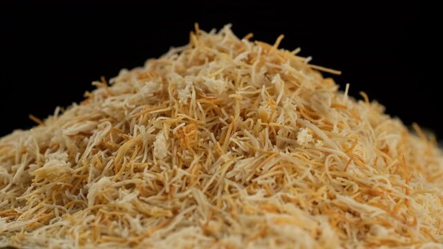 Heap of  Kataifi dough or Kadayif dough isolated on black background, rotation