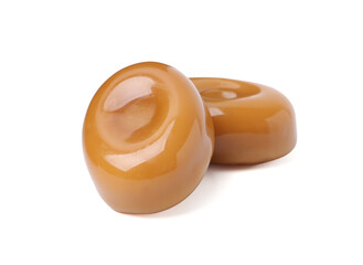 Tasty sweet caramel candies isolated on white