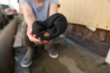 Homeless man with money outdoors, selective focus