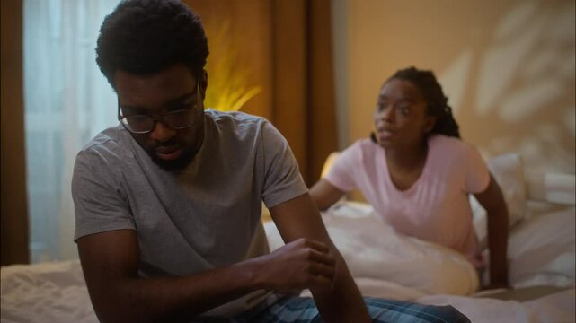 Family divorce argument cheating betrayal couple marriage problems African American ethnic angry woman screaming yell complaining shouting scared man domestic violence fighting at home bedroom night