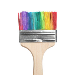 Brush with colorful paints isolated on white