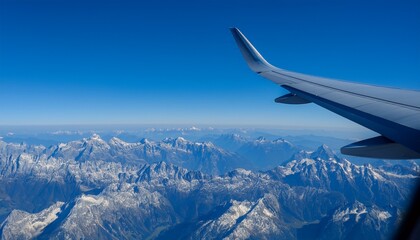 Obraz premium High mountain peaks seen from an airplane window