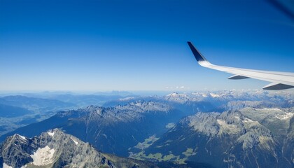 Fototapeta premium High mountain peaks seen from an airplane window
