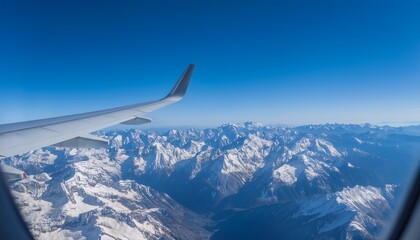 High mountain peaks seen from an airplane window