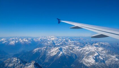 Obraz premium High mountain peaks seen from an airplane window