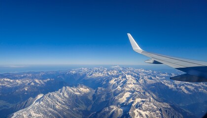 High mountain peaks seen from an airplane window