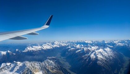 High mountain peaks seen from an airplane window