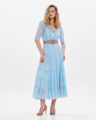 Naklejka premium Girl model in blue dress on white studio background.