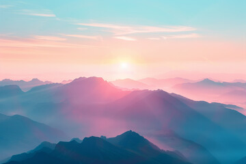 A misty sunrise paints the mountain landscape with soft light across hills and valleys under a blue sky