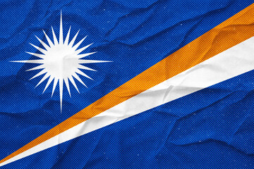 Distressed and textured Marshall Islands flag shows a worn symbol of national identity.