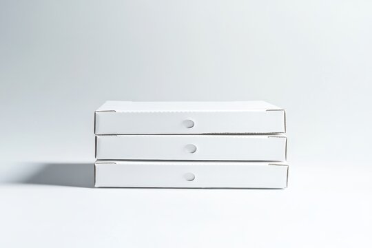 Three stacked blank white cardboard boxes on white background