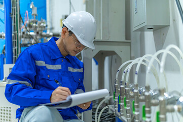 Asian engineer working at Operating hall,Thailand people wear helmet  work,He worked with diligence...