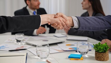Business Handshake Between Professionals in Office Setting