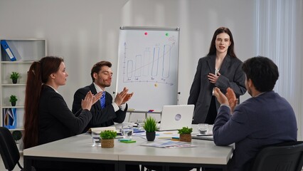 Team Applauding Colleague in Business Meeting Setting