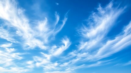 Fototapeta premium Soft blue sky with wispy clouds, leaving plenty of space for text in the middle.