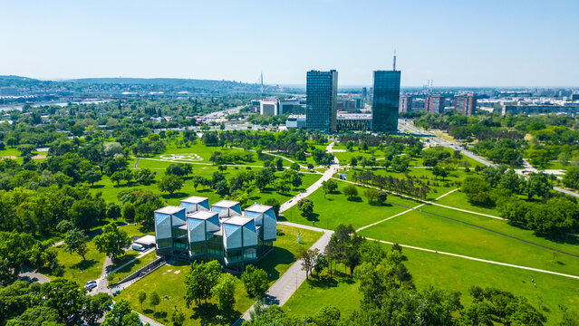Aerial view of Belgrade where the Sava and Danube rivers meet. Visible landmarks include Kalemegdan Fortress (Beogradska tvrđava), city bridges, and U&scaron;će Park &mdash; a perfect urban-meets-nature panorama