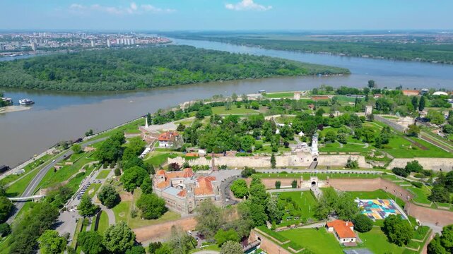 Aerial view of Belgrade where the Sava and Danube rivers meet. Visible landmarks include Kalemegdan Fortress (Beogradska tvrđava), city bridges, and U&scaron;će Park &mdash; a perfect urban-meets-nature panorama