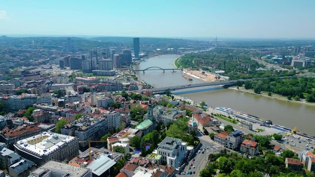 Aerial view of Belgrade where the Sava and Danube rivers meet. Visible landmarks include Kalemegdan Fortress (Beogradska tvrđava), city bridges, and U&scaron;će Park &mdash; a perfect urban-meets-nature panorama