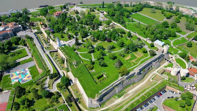 Aerial view of Belgrade where the Sava and Danube rivers meet. Visible landmarks include Kalemegdan Fortress (Beogradska tvrđava), city bridges, and U&scaron;će Park &mdash; a perfect urban-meets-nature panorama