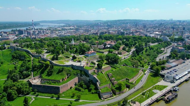 Aerial view of Belgrade where the Sava and Danube rivers meet. Visible landmarks include Kalemegdan Fortress (Beogradska tvrđava), city bridges, and U&scaron;će Park &mdash; a perfect urban-meets-nature panorama
