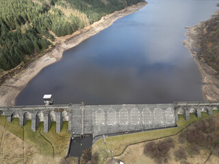 concrete dam of Loch Tarsan freshwater loch and impounding reservoir water supply near Dunoon Scotland. manmade structure in wild nature feeds Striven Hydro-Electric Scheme 