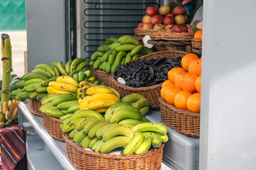 Colorful assortment of tropical fruits and vegetables in traditional market stall