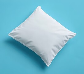 White pillow on a bright blue background.  A blank, rectangular pillow, resting flat against a solid, vibrant backdrop