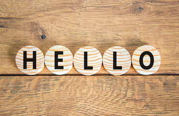 Fototapeta premium Hello symbol. Concept word Hello on beautiful wooden circles. Beautiful wooden table wooden background. Business lifestyle hello concept. Copy space.
