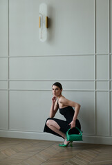 Fototapeta premium Girl model in the interior in stylish clothes with a bag. style fashion.