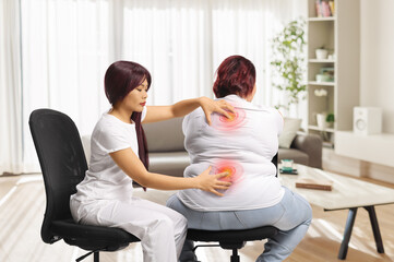 Female massage therapist treating an overweight woman