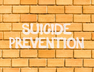 Suicide prevention symbol. Concept words Suicide prevention on beautiful brick wall. Beautiful...