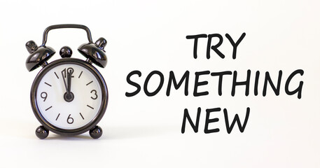 Try something new symbol. Concept words Try something new on beautiful white paper. Alarm clock. Beautiful white paper background. Business motivational lifestyle try something new concept. Copy space