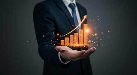 Businessman presenting an upward trending bar graph with arrow in his open hand with sparkles real estate business ,technology ,selling ,purchasing ,agreement