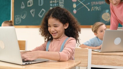 Attractive girl coding prompt while looking at camera at STEM class while happy teacher checking...