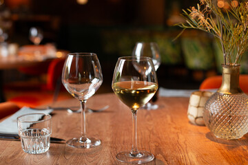 A glass of white wine on a table, perfect for relaxation, dining, or celebration themes