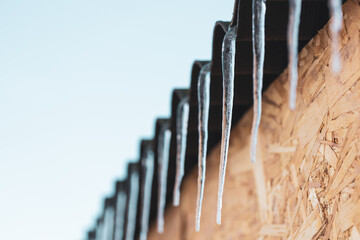 icicles hanging from the roof, the beginning of warm days