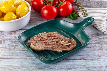 Grilled lamb steak with bone