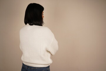 A woman arms crossed on her breast, symbolizing confidence and perseverance. Her posture conveys...