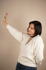 A universal expression of halting action or setting boundaries. A single hand raised with an open palm delivers a clear "stop" signal. The firm gesture conveys authority and the need to pause.