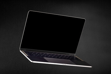 Modern Laptop Computer with Blank Black Screen Floating on Dark Background – Generic Silver Notebook for Commercial, Business, or Technology Use