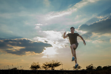 Silhouette of a man running against a colorful sky. Silhouette of a man running against a sunset background.