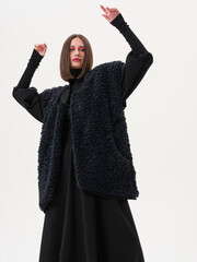 Portrait of a girl model in stylish clothes, in the studio on a light background.