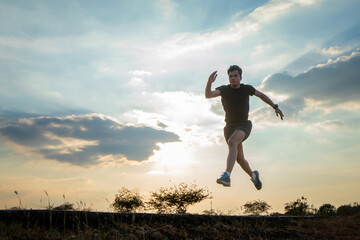 Silhouette of a man running against a colorful sky. Silhouette of a man running against a sunset background.