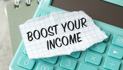 A calculator with a piece of paper on top that says Boost Your Income